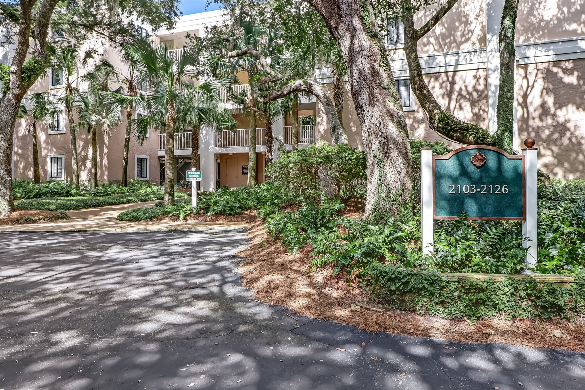 2117 Beachwood Road, Unit 2117 Fernandina Beach, FL 32034 - Photo 21 of 36 a pathway of a house with a yard and large trees
