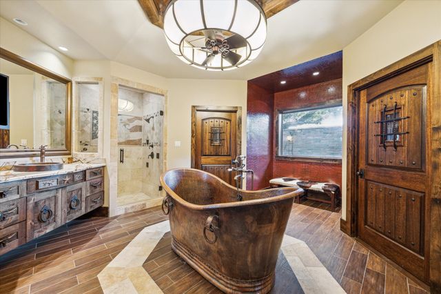 a kitchen with stainless steel appliances granite countertop a sink and a refrigerator