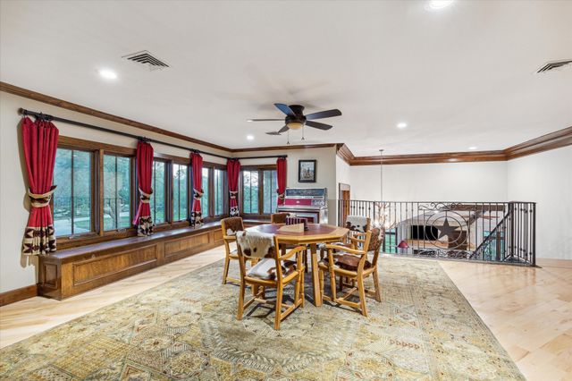 a view of a dining room with furniture floor to ceiling window and floor to ceiling window