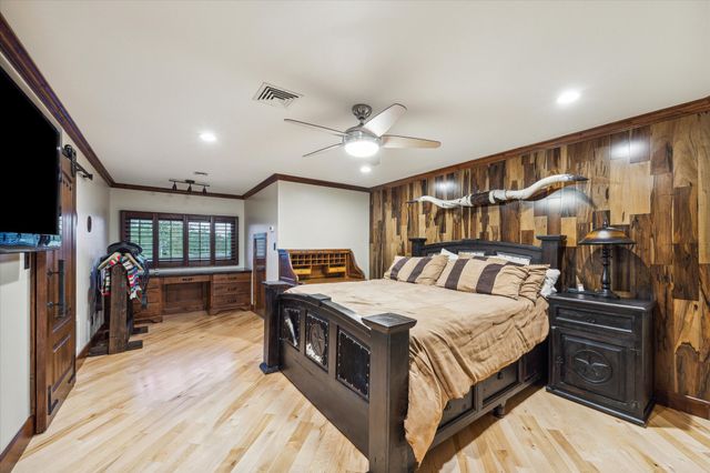 a spacious bedroom with a bed and a chandelier