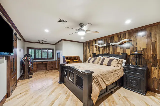 a spacious bedroom with a bed and a chandelier