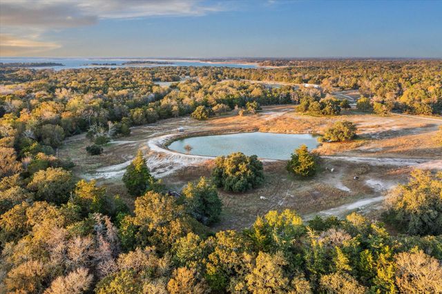 a view of a room with table wooden floor and windows