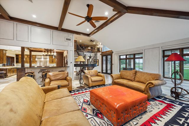 a living room with furniture a rug and a chandelier