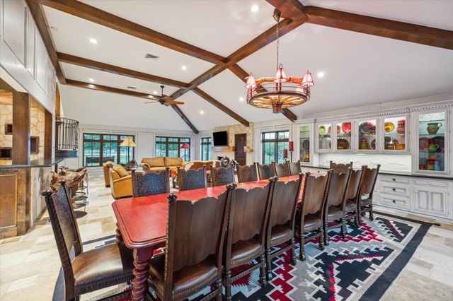 a dining room with furniture a rug and a chandelier
