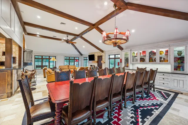 a dining room with furniture a rug and a chandelier