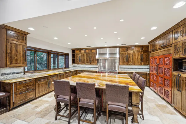 a dining table with chairs and window