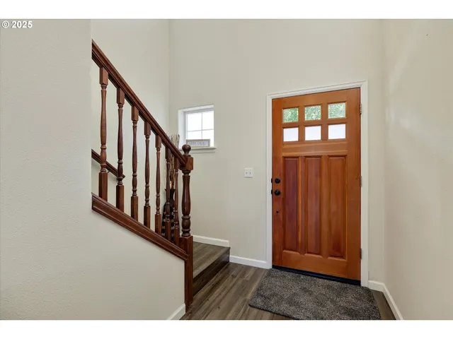 a view of staircase with lots of wooden furniture