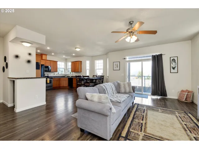 a living room with furniture and kitchen view