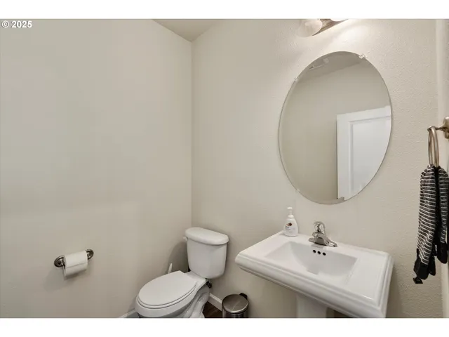 a bathroom with a sink mirror and toilet