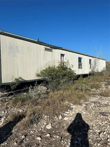 a view of a back yard with a wooden fence