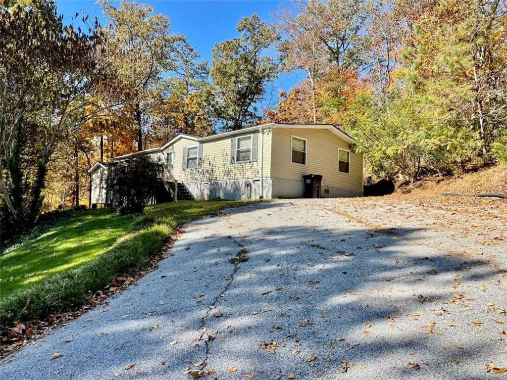 2076 Carr Road Northeast Conyers, GA 30012 - Photo 1 of 1 a front view of a house with a yard covered with trees