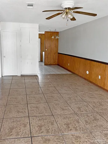 a view of a kitchen with refrigerator and window
