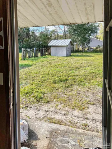 a view of an empty room and a window