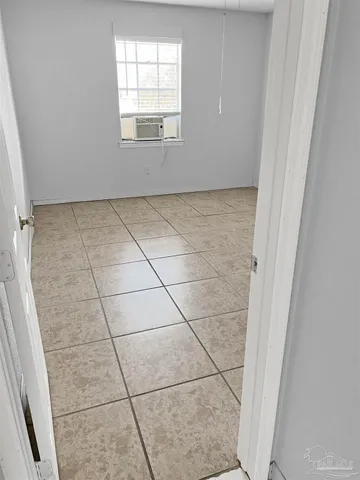 a view of an empty room with a fireplace