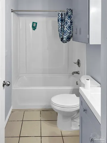 a view of a room with white tiles and a window