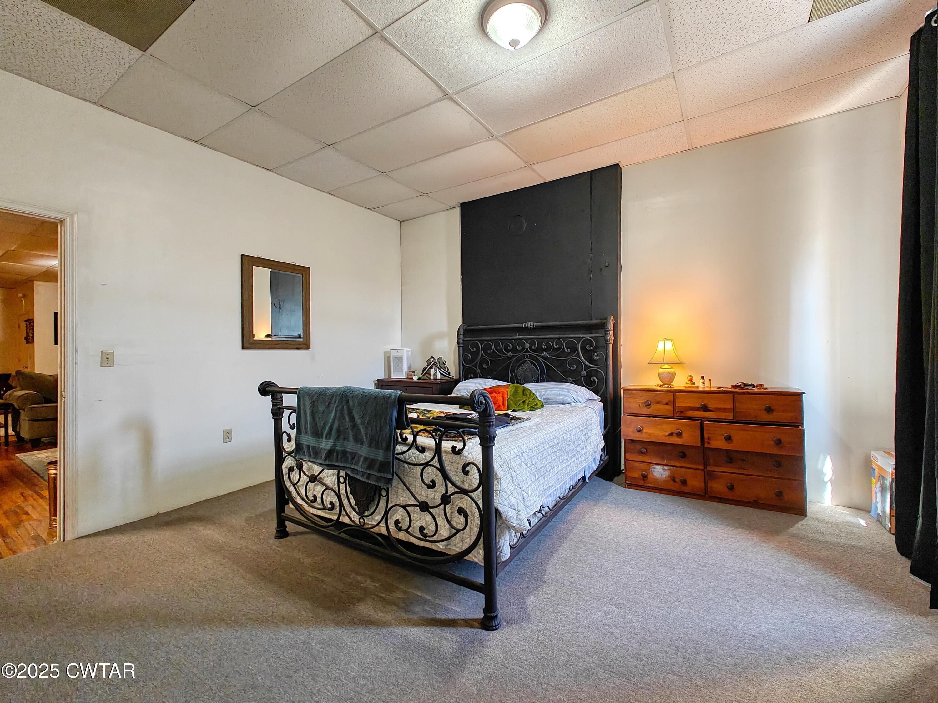 121 North Poplar Street Paris, TN 38242 - Photo 17 of 38 a bed room with furniture and a flat screen tv