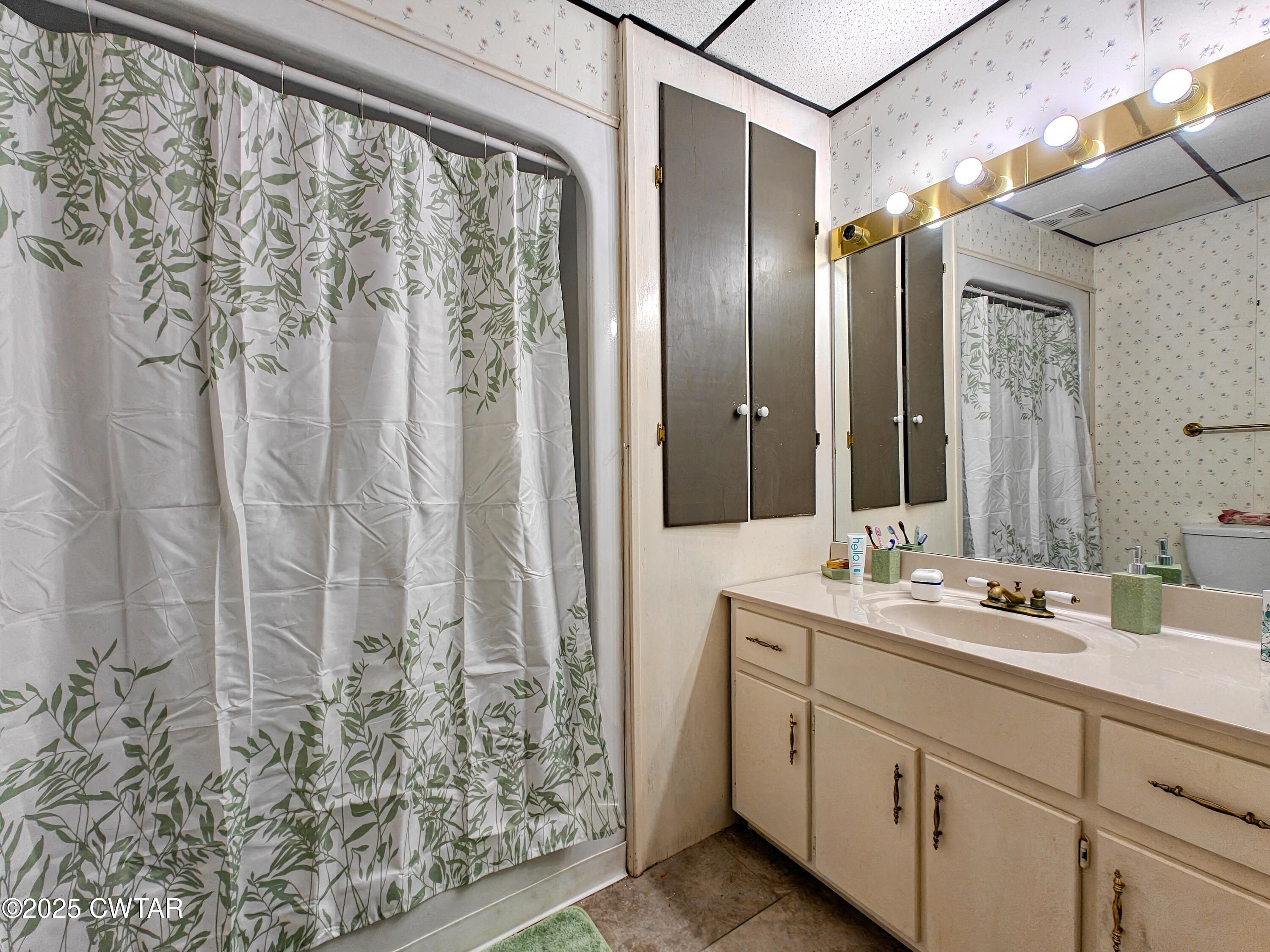 121 North Poplar Street Paris, TN 38242 - Photo 19 of 38 a bathroom with a double vanity sink and mirror
