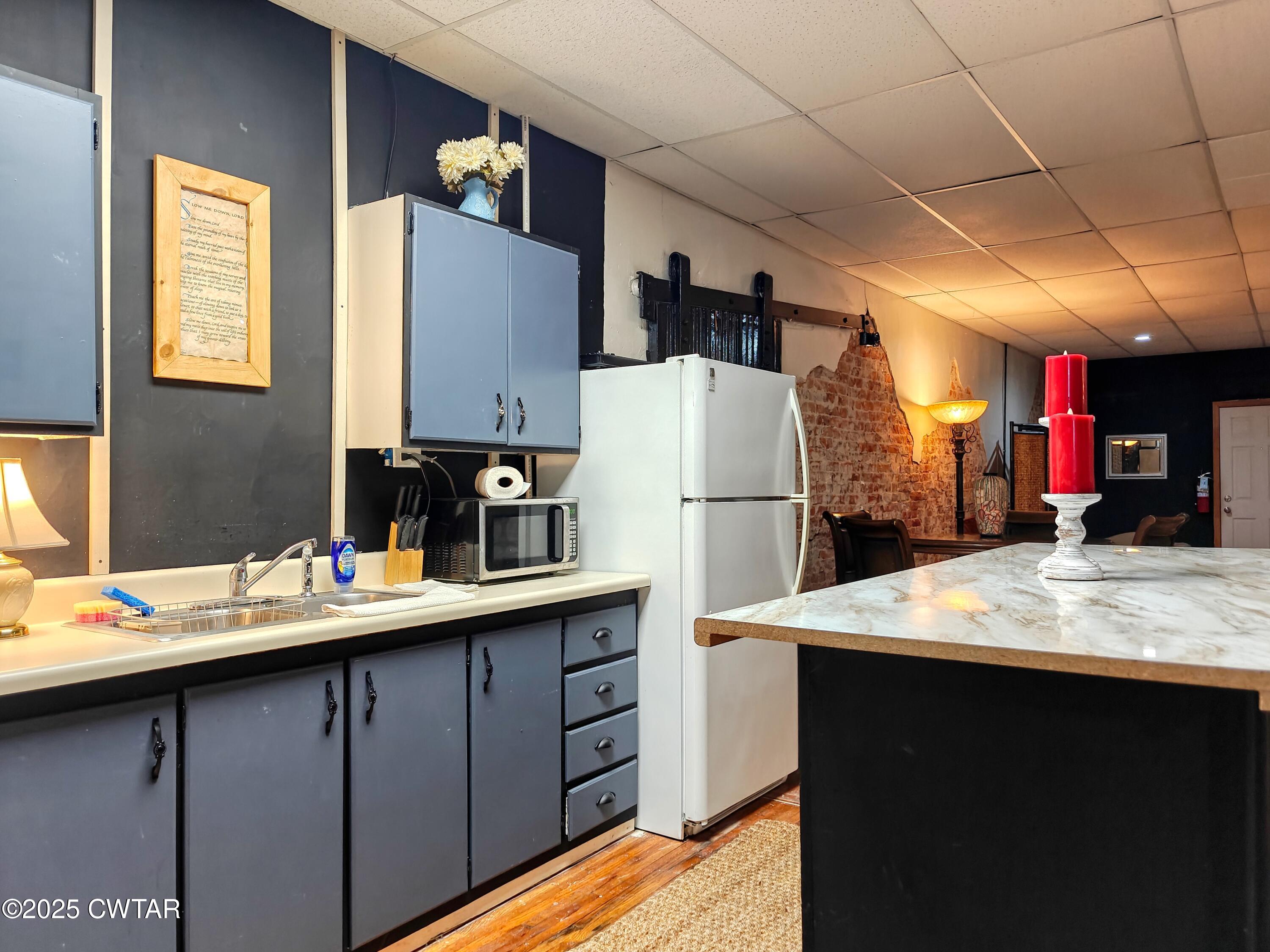 121 North Poplar Street Paris, TN 38242 - Photo 20 of 38 a kitchen that has a sink and a refrigerator