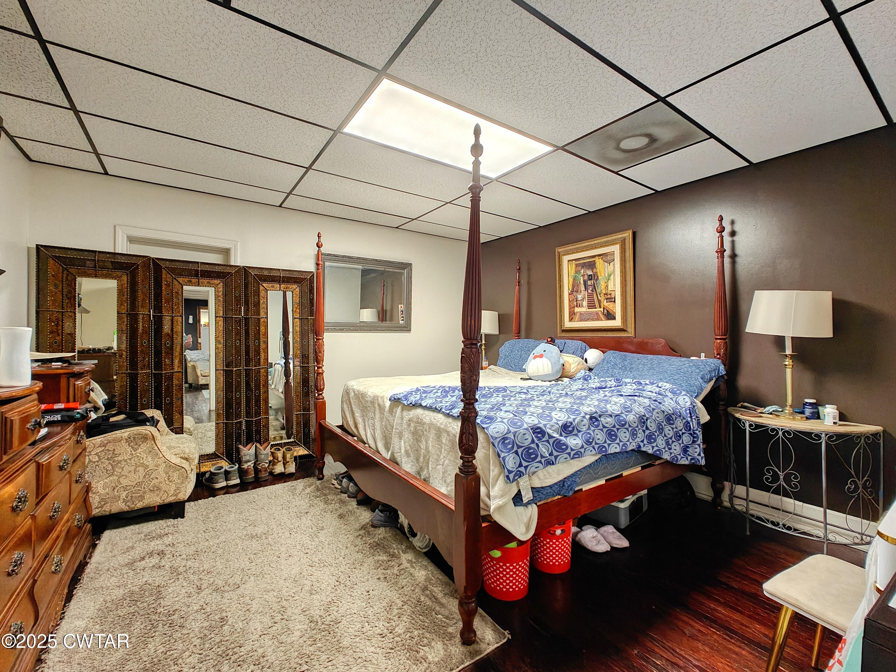 121 North Poplar Street Paris, TN 38242 - Photo 26 of 38 a bedroom with a bed a lamp and large window