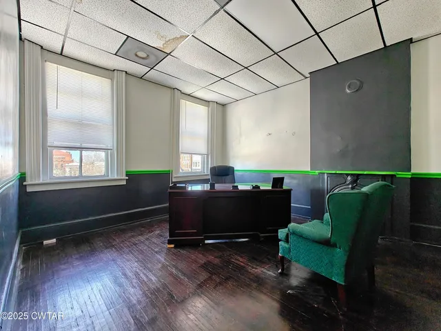 a living room with stainless steel appliances granite countertop lots of wooden floors