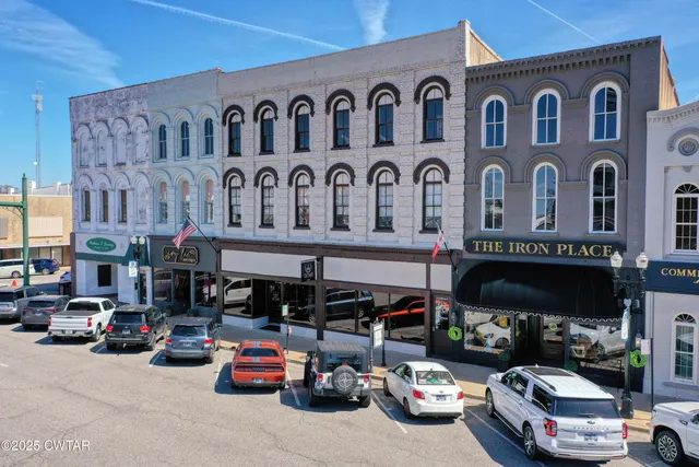 a front view of a building with parking