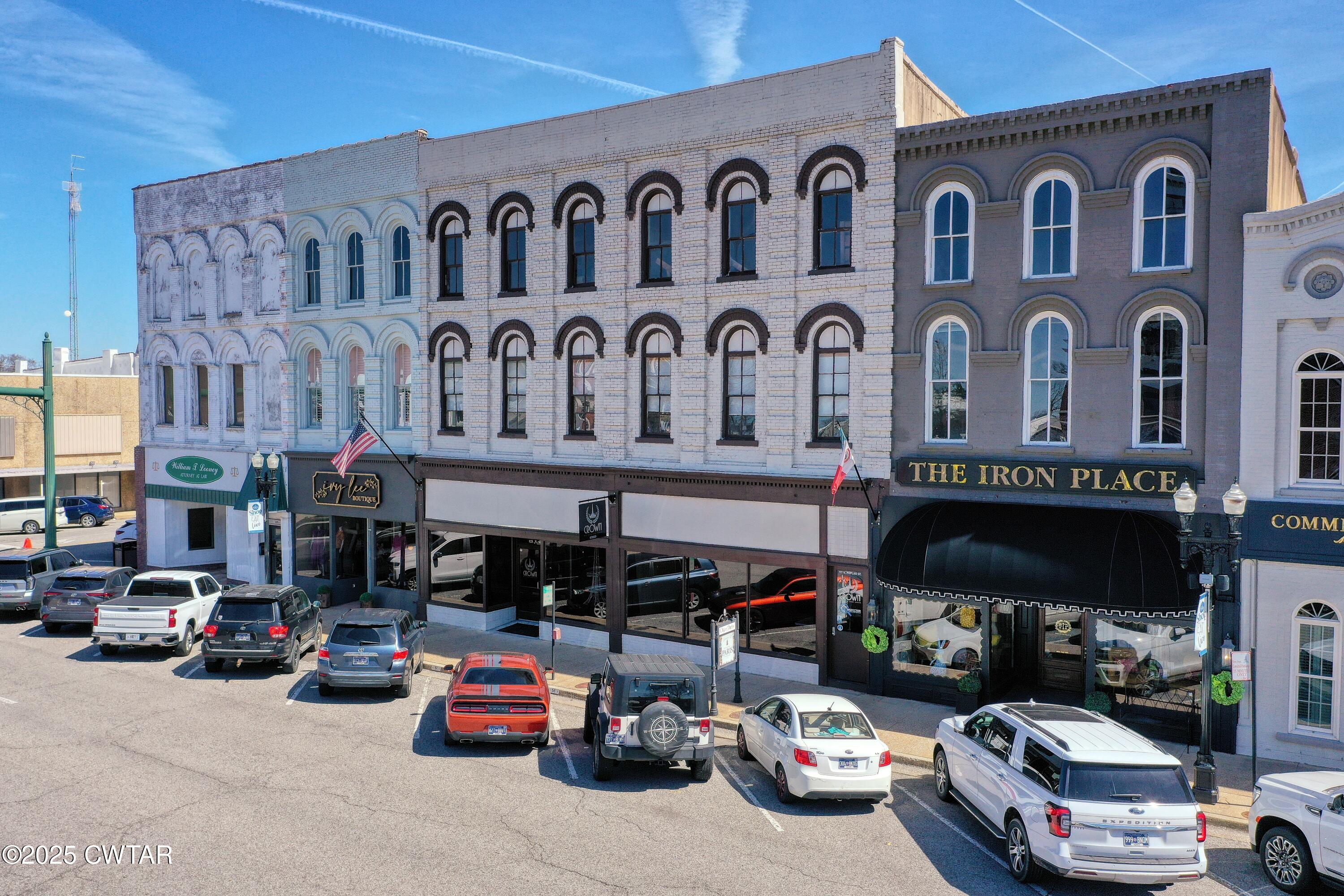121 North Poplar Street Paris, TN 38242 - Photo 3 of 38 a car parked in front of a building