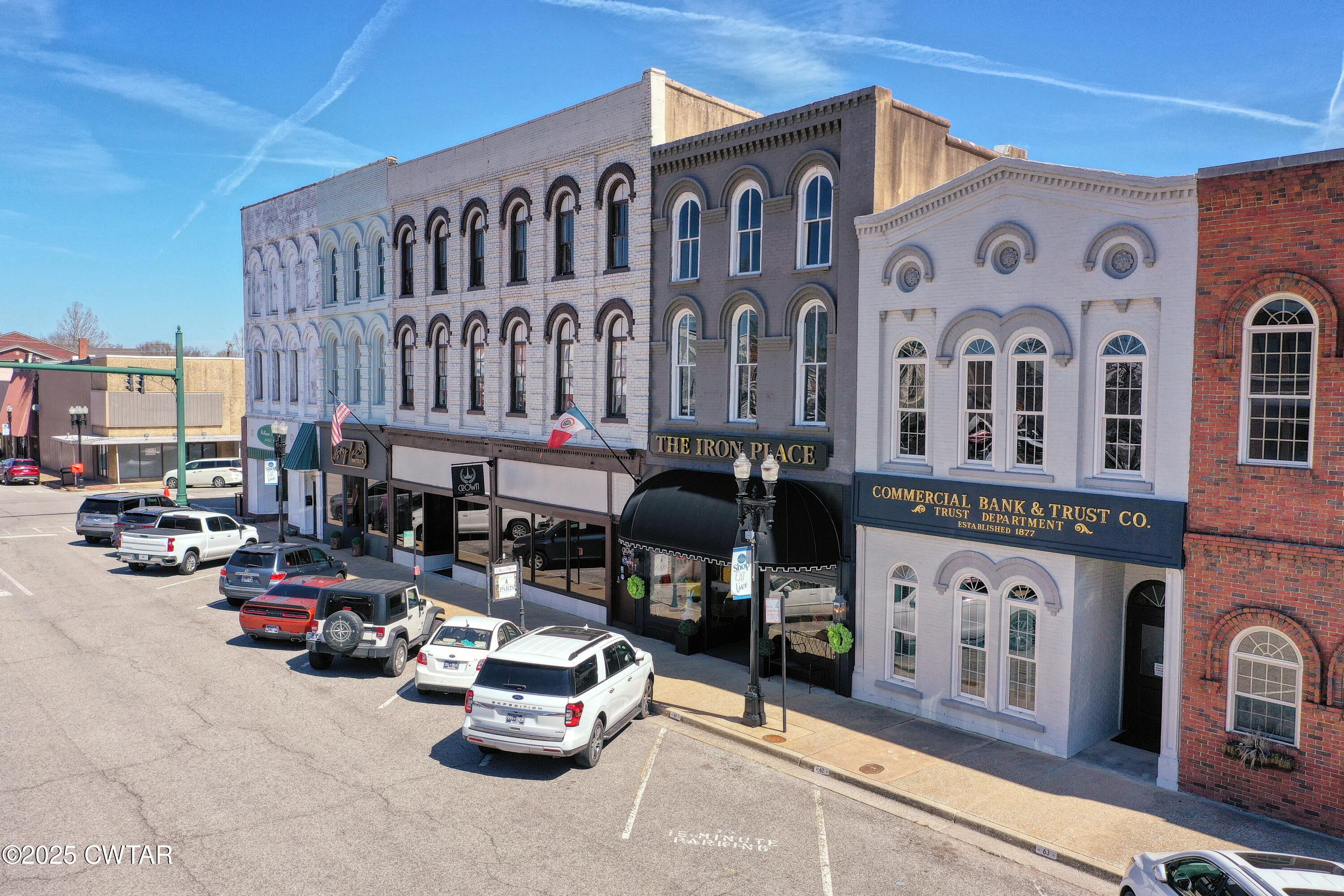 121 North Poplar Street Paris, TN 38242 - Photo 4 of 38 a front view of a building with parking