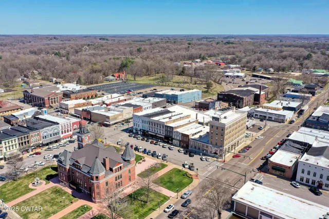 an aerial view of a city with parking