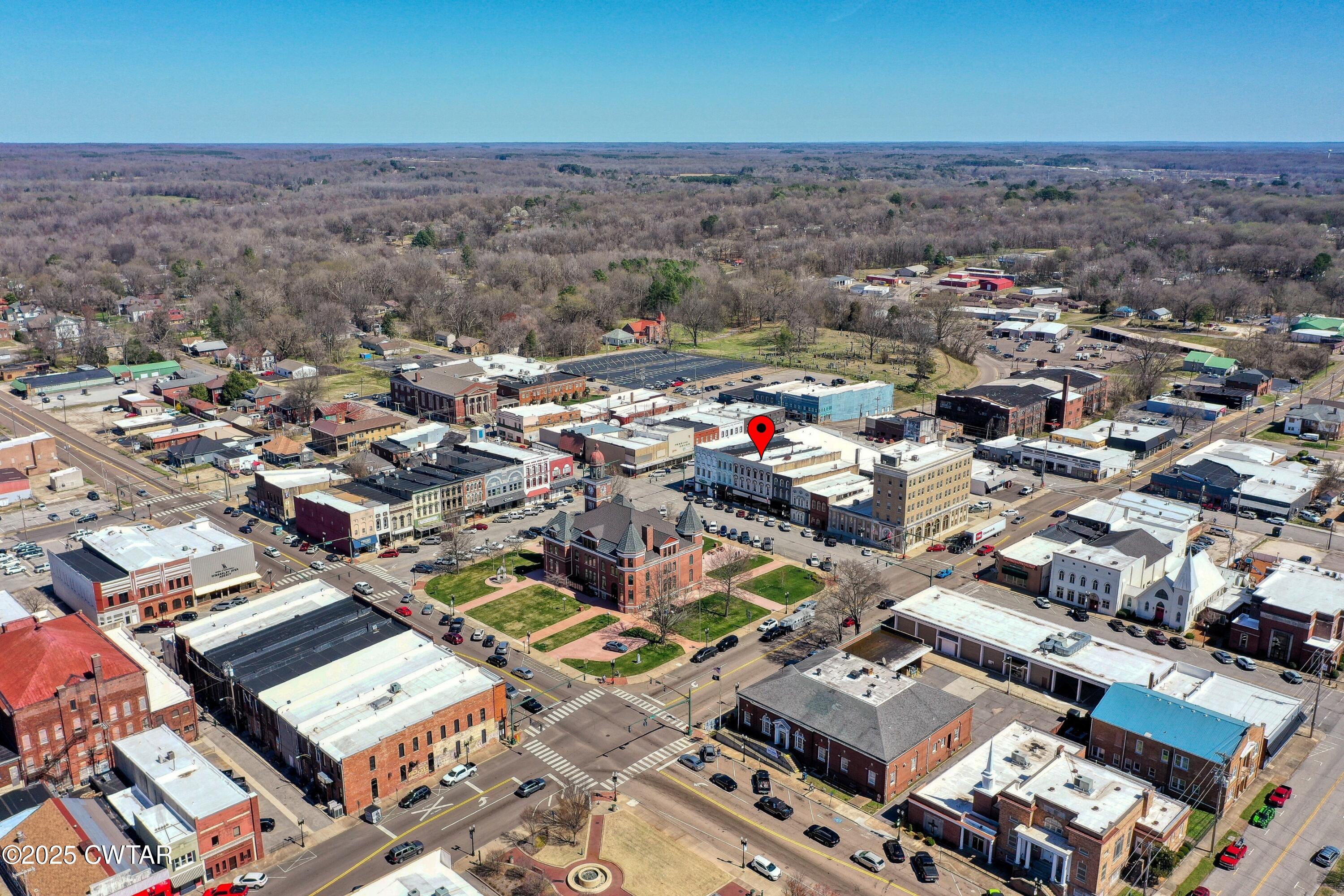121 North Poplar Street Paris, TN 38242 - Photo 7 of 38 an aerial view of a city with parking