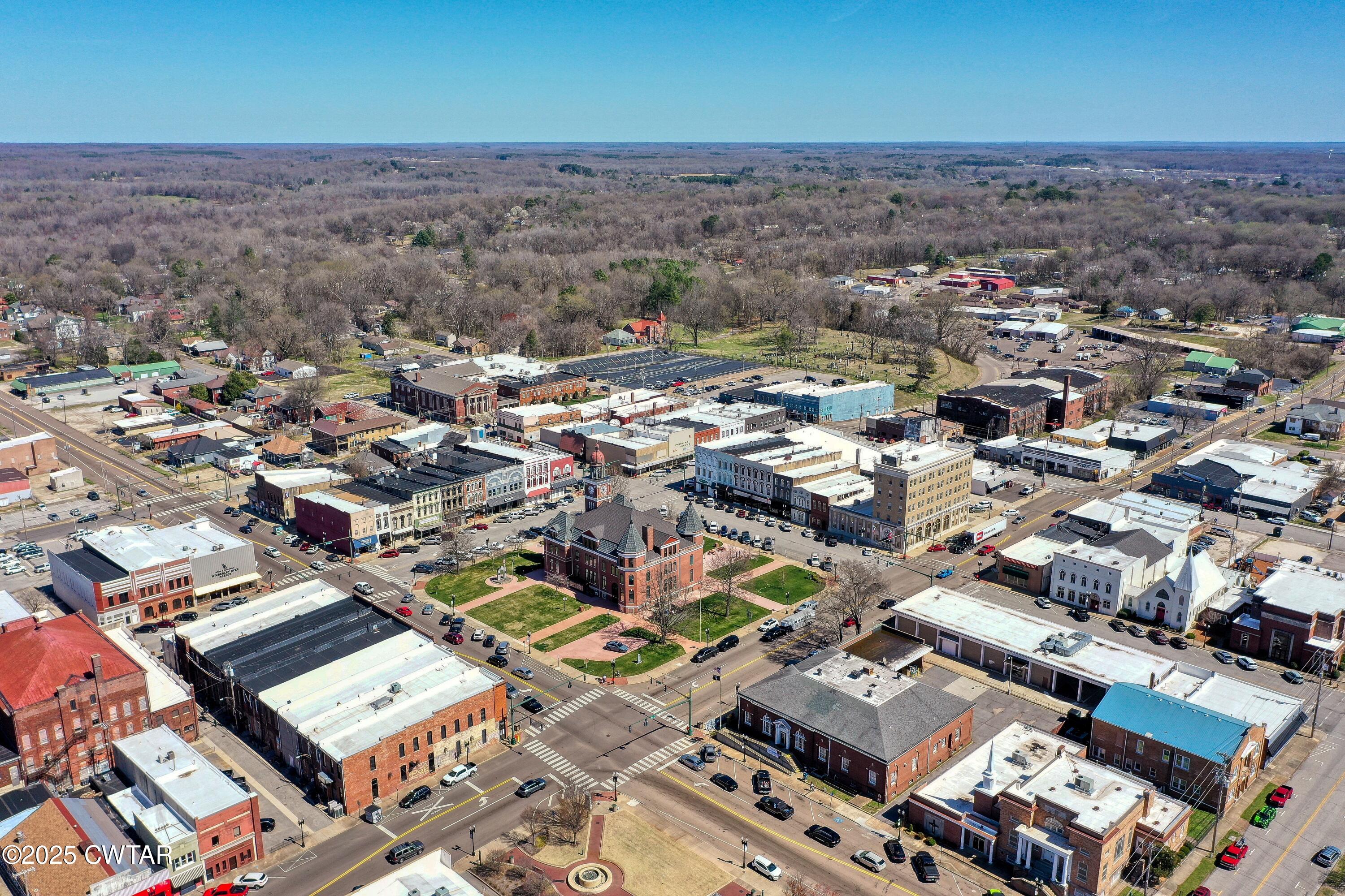 121 North Poplar Street Paris, TN 38242 - Photo 8 of 38 an aerial view of a city with parking