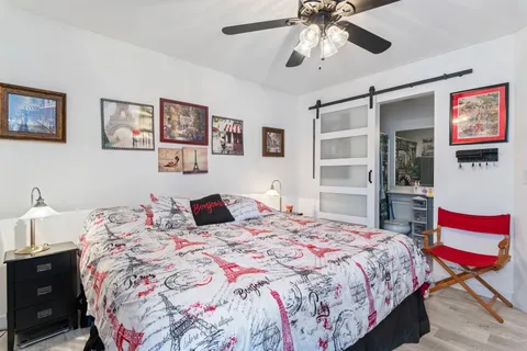 a bedroom with a bed and a chandelier