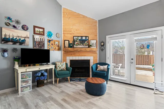 a front view of a house with a big yard and large trees