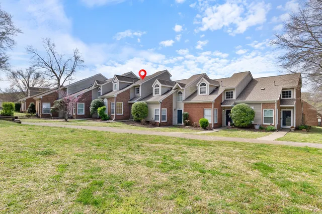 an aerial view of a houses with a swimming pool