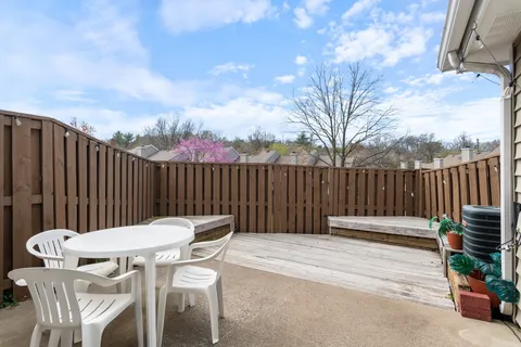 a view of a chairs and tables in the back yard of the house