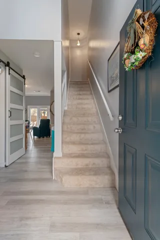 a view of entryway and hall with wooden floor