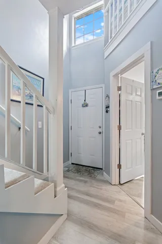 wooden floor with white walls and stairs