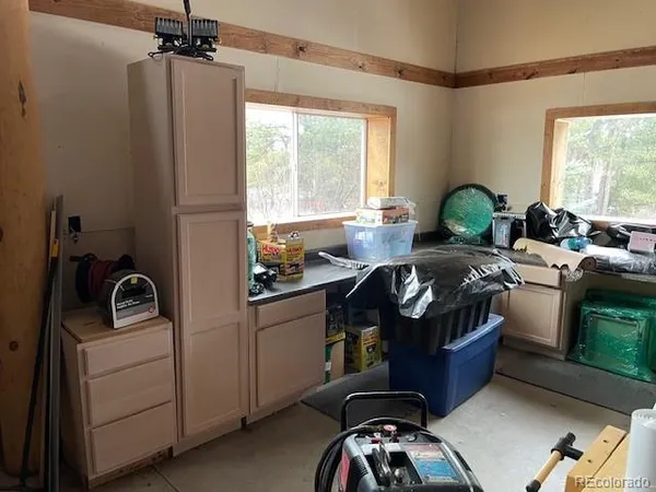 a kitchen with stainless steel appliances kitchen island a stove a sink and a window