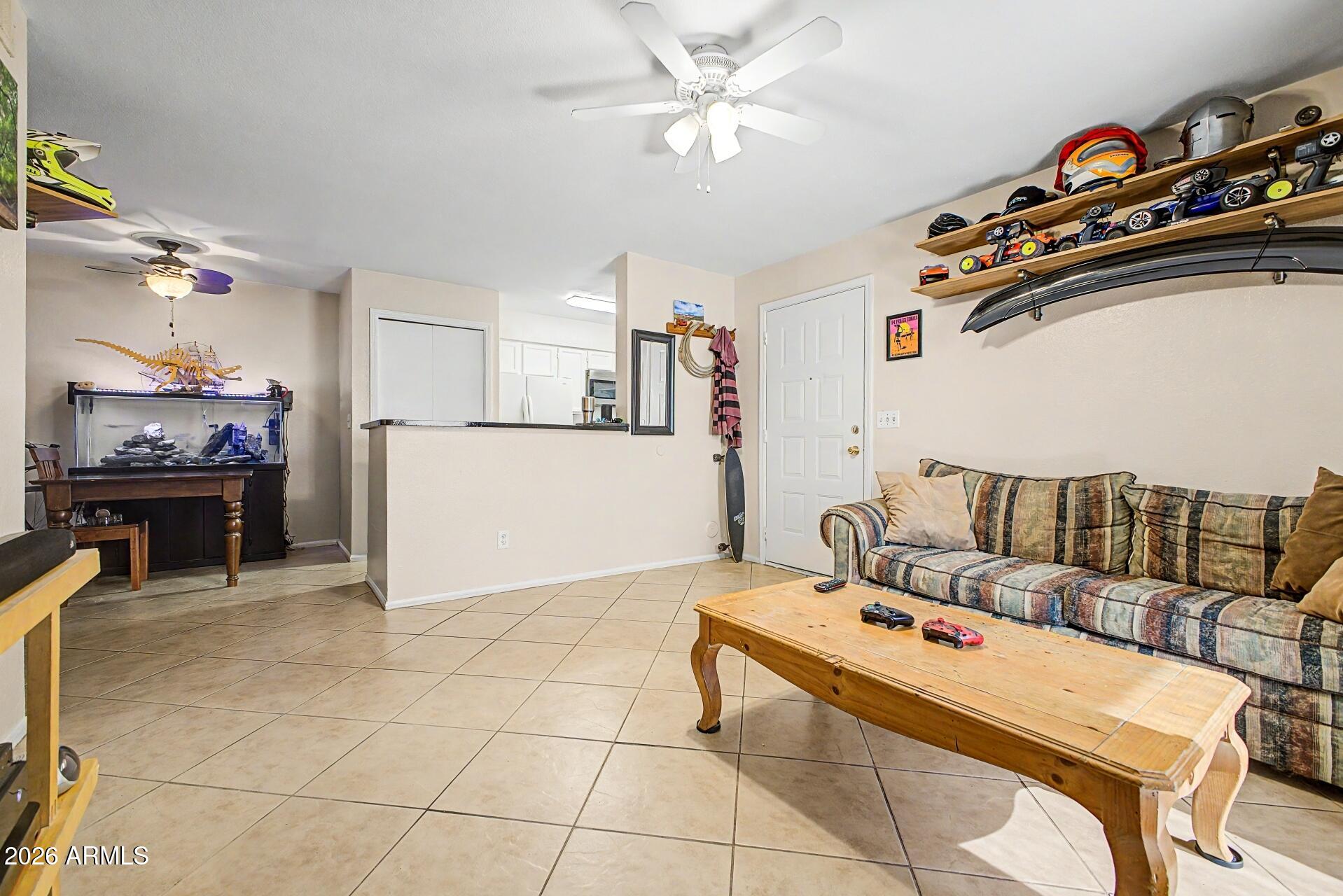 533 West Guadalupe Road, Unit 1104 Mesa, AZ 85210 - Photo 2 of 20 a living room with furniture and a flat screen tv