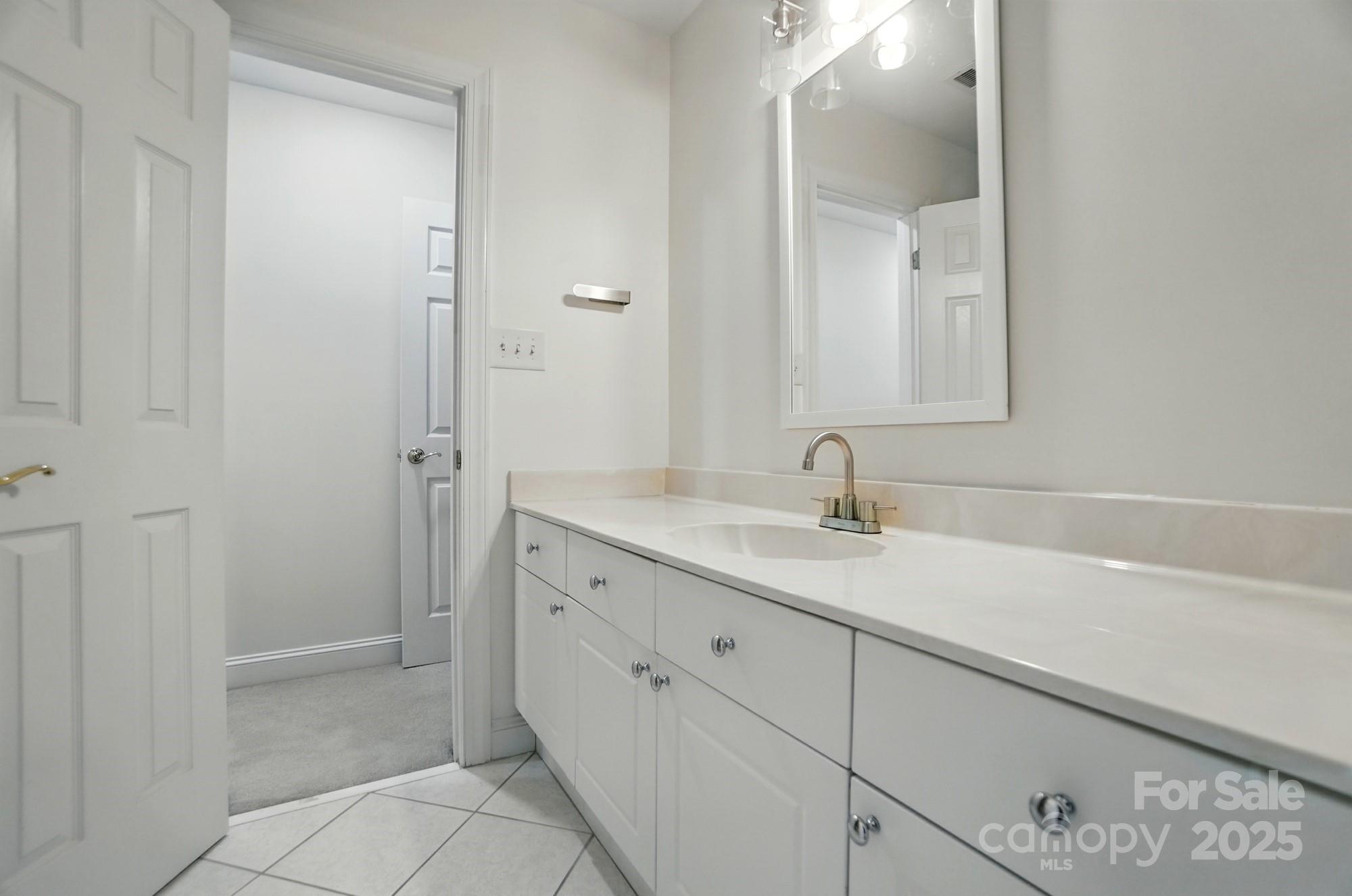 201 Limerick Drive Matthews, NC 28104 - Photo 22 of 34 a bathroom with a sink and a mirror