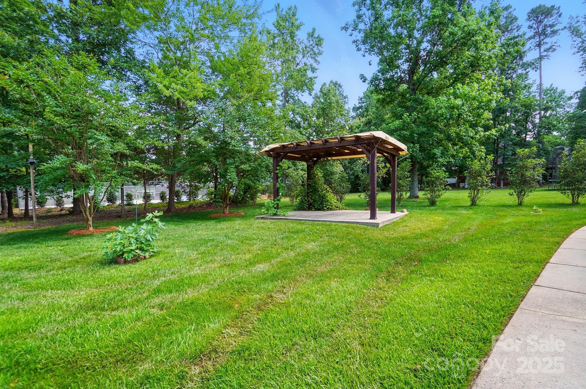 201 Limerick Drive Matthews, NC 28104 - Photo 31 of 34 a view of a garden with a bench