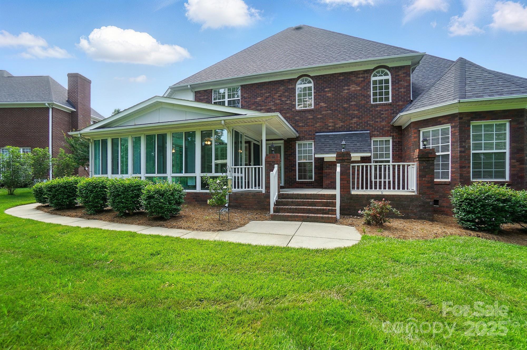 201 Limerick Drive Matthews, NC 28104 - Photo 32 of 34 a front view of a house with a yard and green space