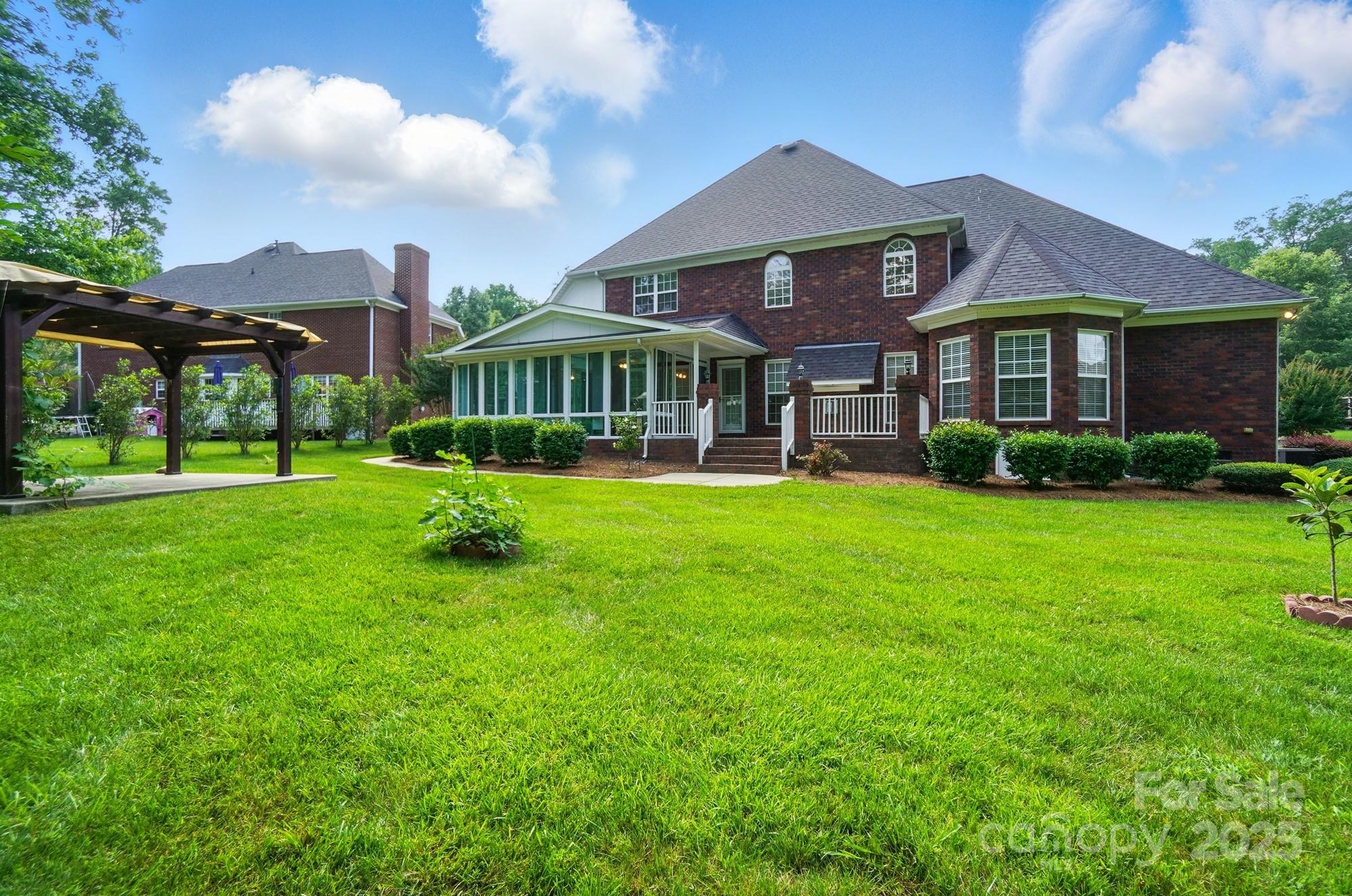 201 Limerick Drive Matthews, NC 28104 - Photo 33 of 34 a front view of a house with a yard table and plants