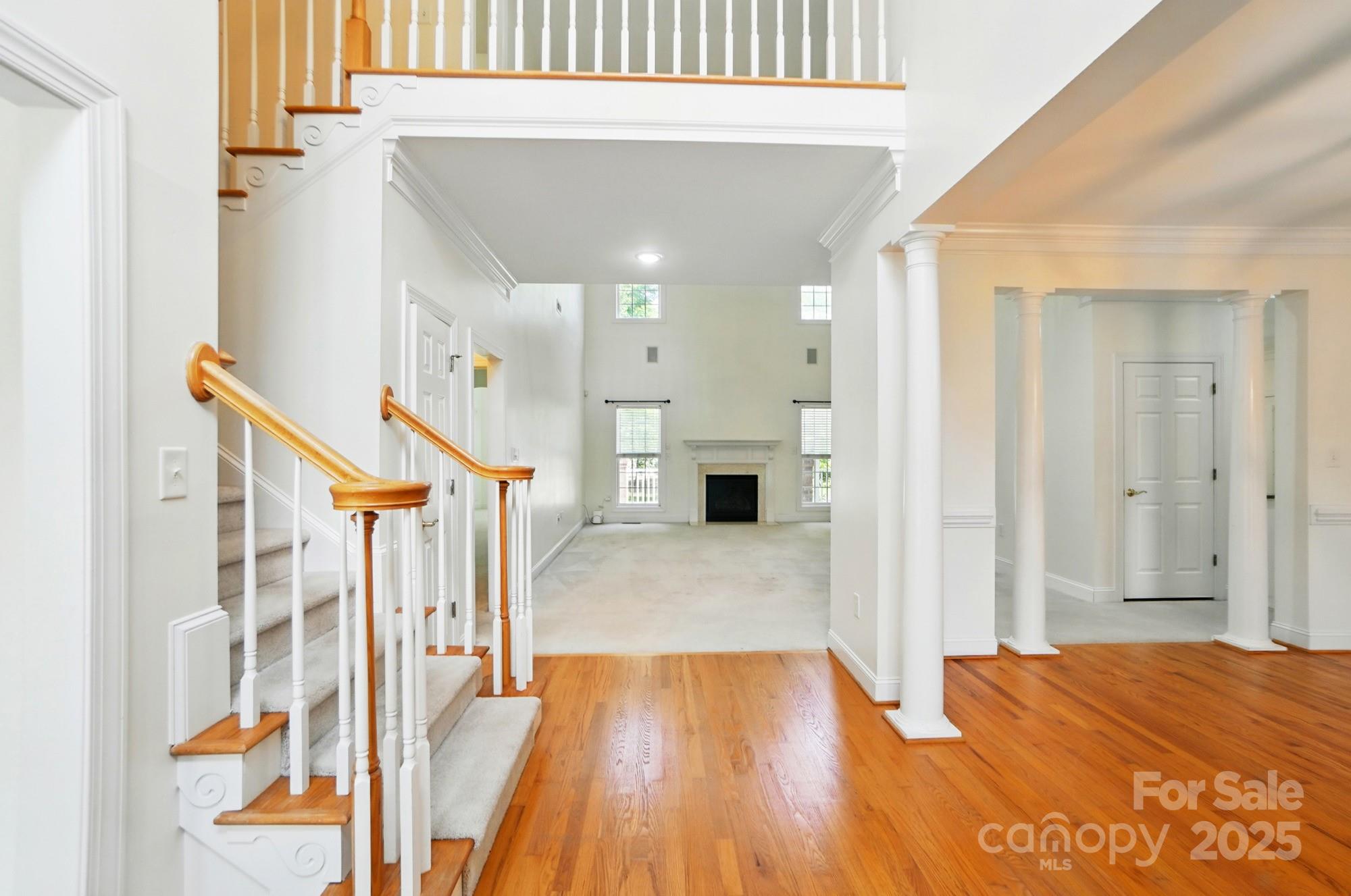201 Limerick Drive Matthews, NC 28104 - Photo 6 of 34 a view of empty room with wooden floor and staircase