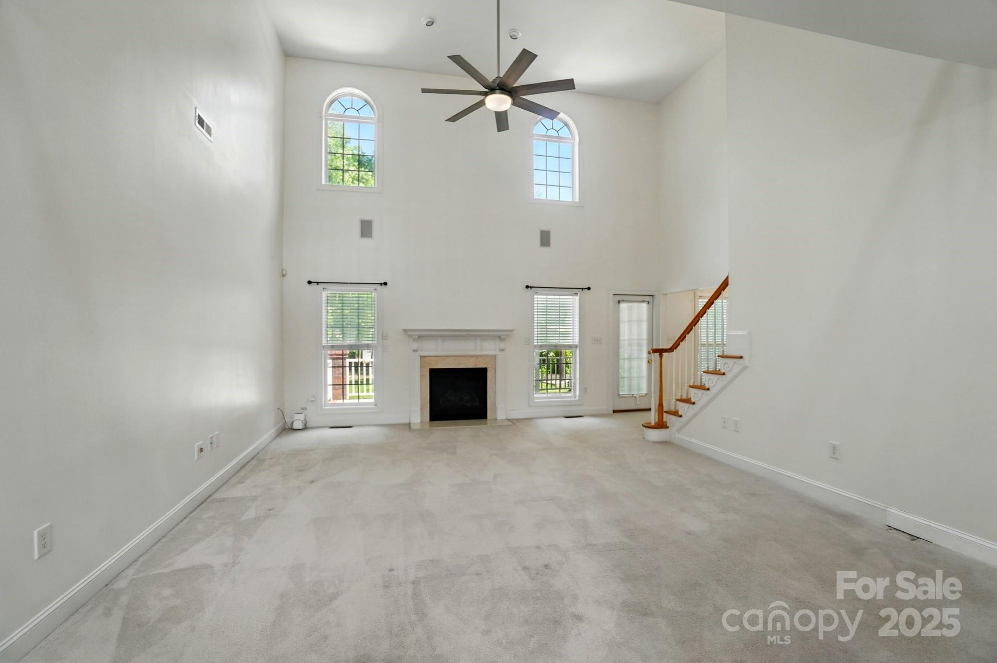 201 Limerick Drive Matthews, NC 28104 - Photo 8 of 34 an empty room with windows and fireplace