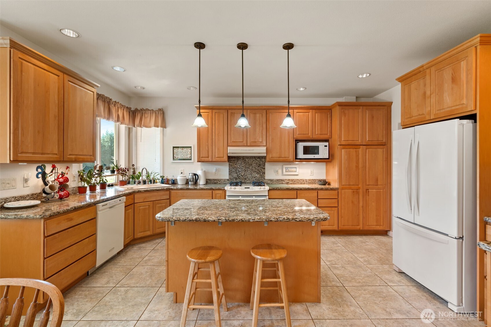 301 Russell Road Winlock, WA 98596 - Photo 4 of 40 a kitchen with stainless steel appliances granite countertop a refrigerator a sink a stove a dining table and chairs