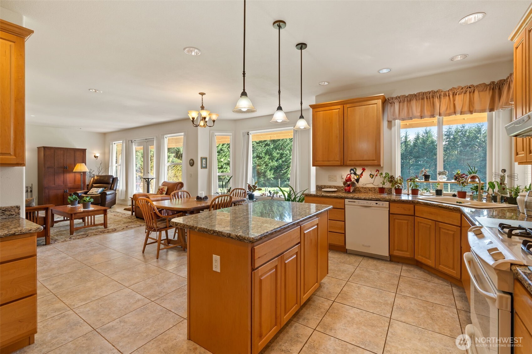 301 Russell Road Winlock, WA 98596 - Photo 5 of 40 a kitchen with stainless steel appliances granite countertop sink stove and white cabinets