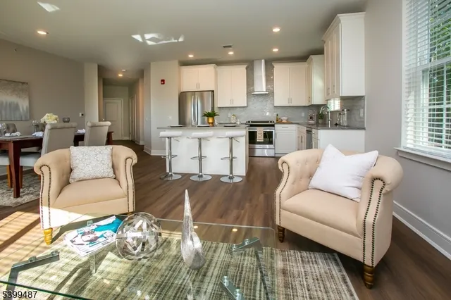 a living room with furniture and a kitchen