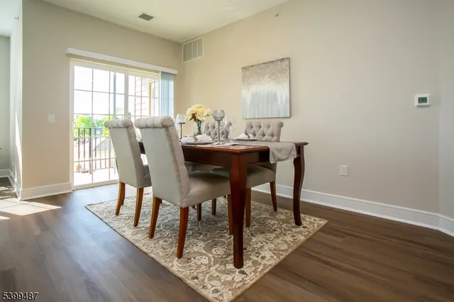 a dining room with furniture and wooden floor