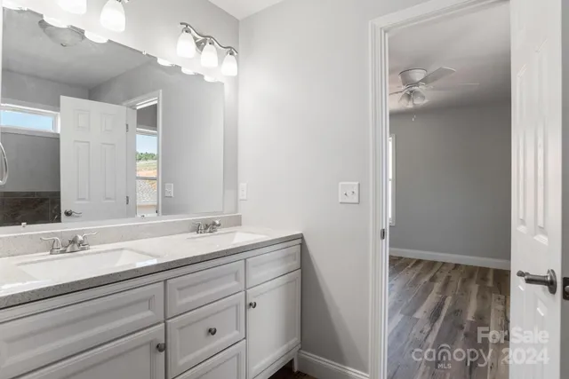 a bathroom with a double vanity sink and a mirror