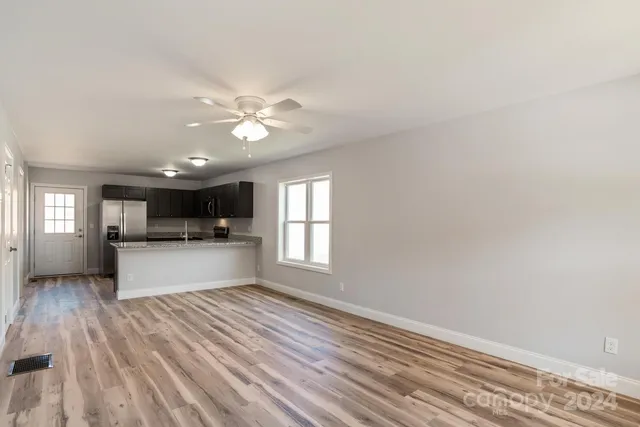 a view of kitchen with refrigerator and window